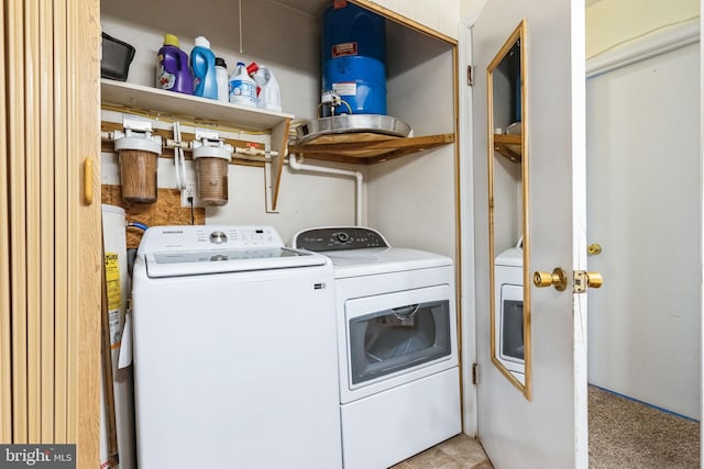 laundry area featuring light colored carpet and washer and dryer