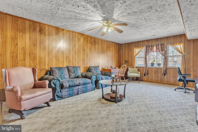 living room with light carpet, wood walls, ceiling fan, and a textured ceiling