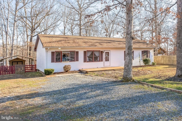 single story home featuring a storage unit