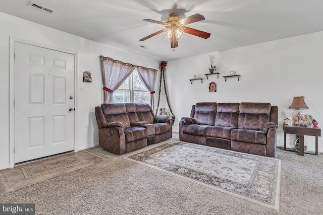 living room featuring ceiling fan and carpet