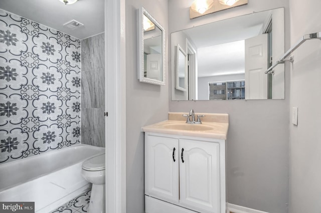 full bathroom with vanity, tiled shower / bath combo, and toilet