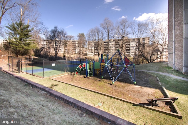 view of jungle gym featuring a yard and tennis court