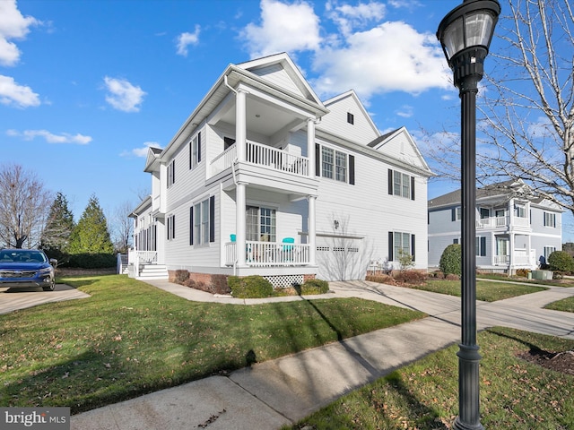 view of front of property with a balcony and a front lawn