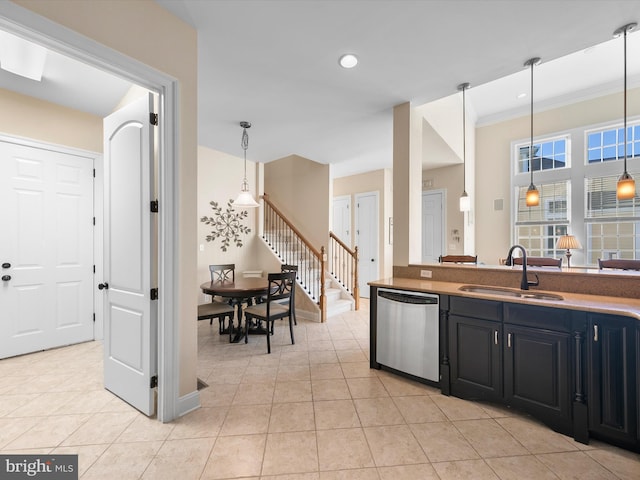 kitchen with crown molding, sink, stainless steel dishwasher, light tile patterned floors, and decorative light fixtures