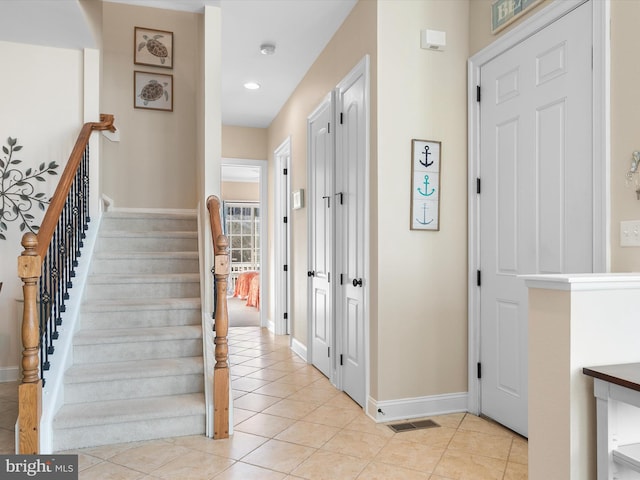 staircase with tile patterned floors