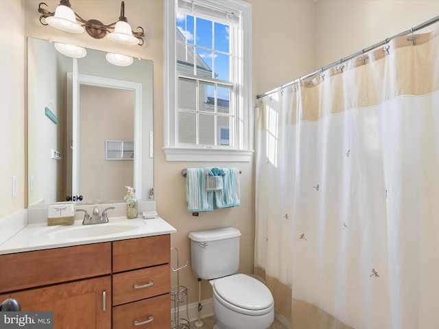 bathroom featuring vanity and toilet