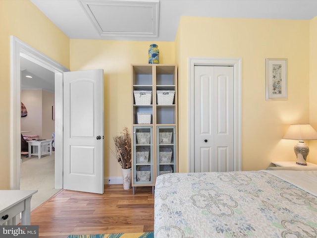 bedroom with wood-type flooring and a closet