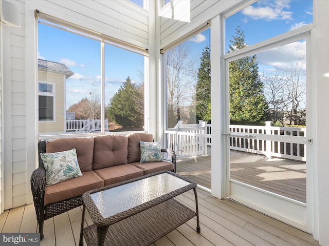 sunroom / solarium with a wall mounted AC