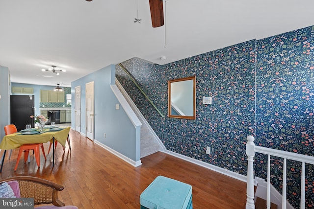 interior space with ceiling fan and wood-type flooring