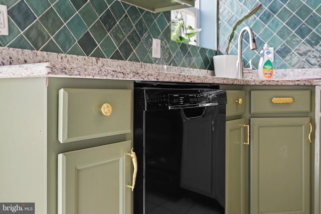 kitchen with dishwasher, light stone counters, and sink