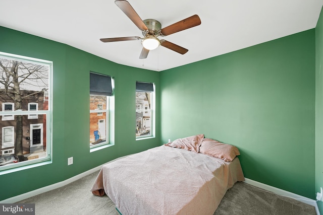 bedroom with ceiling fan and carpet floors