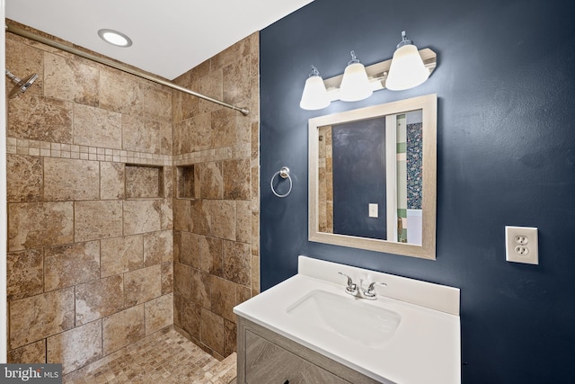 bathroom with vanity and tiled shower