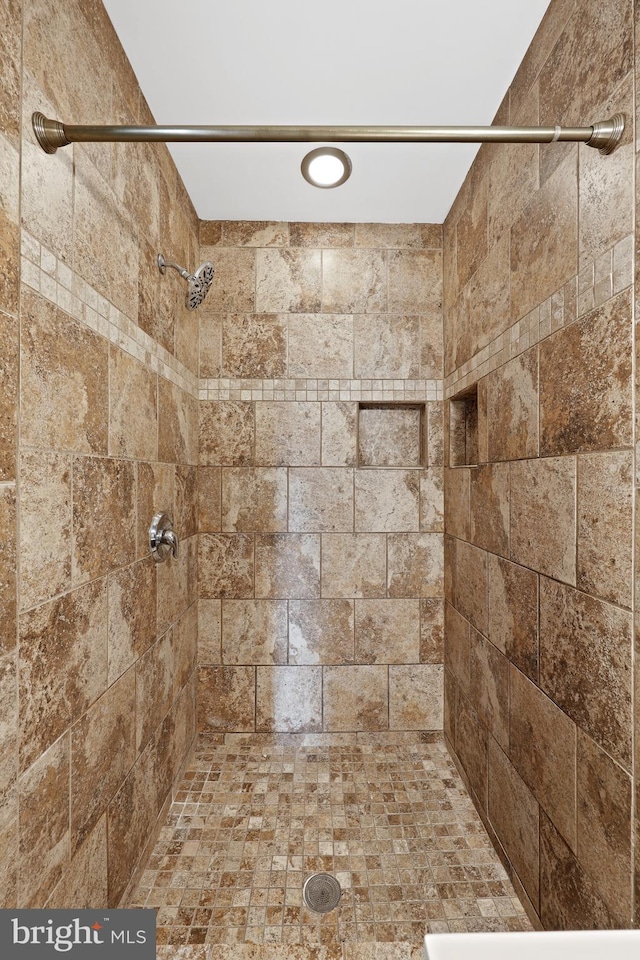 bathroom with tiled shower