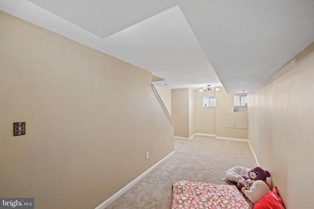 basement featuring light colored carpet