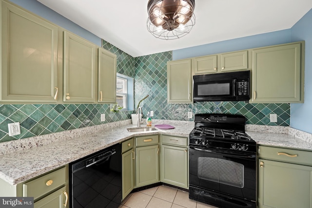 kitchen with light stone counters, sink, black appliances, light tile patterned floors, and cream cabinets