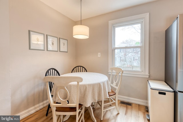 dining space with light hardwood / wood-style floors