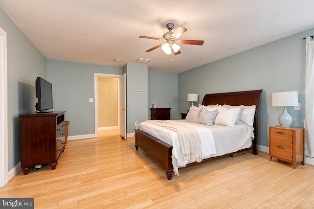 bedroom with ceiling fan and light hardwood / wood-style flooring