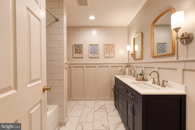 bathroom with vanity and tiled shower / bath combo