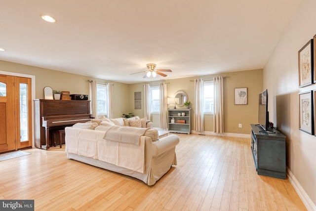 living room with ceiling fan and light hardwood / wood-style floors