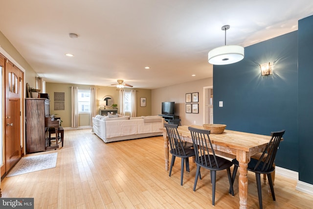 dining space featuring ceiling fan and light hardwood / wood-style floors