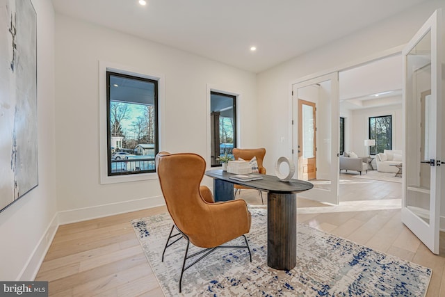 sitting room with french doors and light wood-type flooring