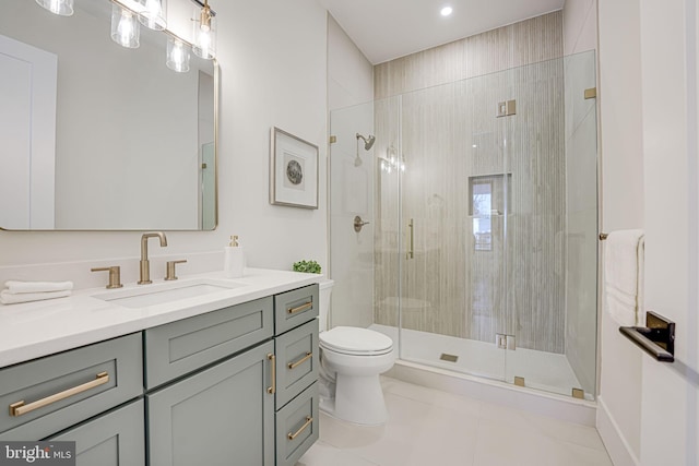 bathroom with toilet, a shower with door, tile patterned floors, and vanity