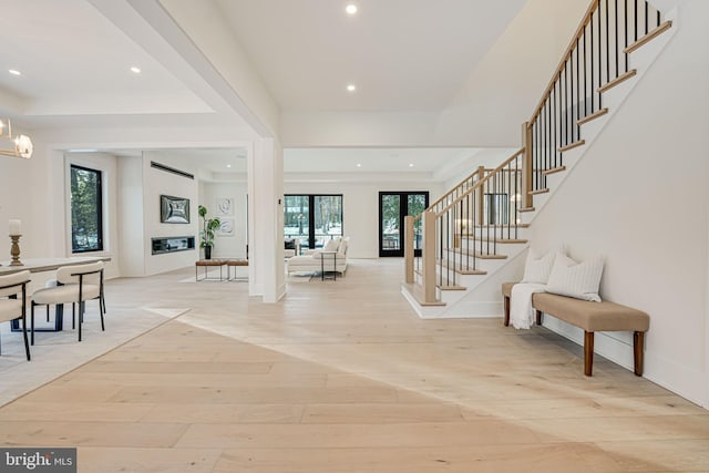 foyer with light hardwood / wood-style flooring and a wall unit AC