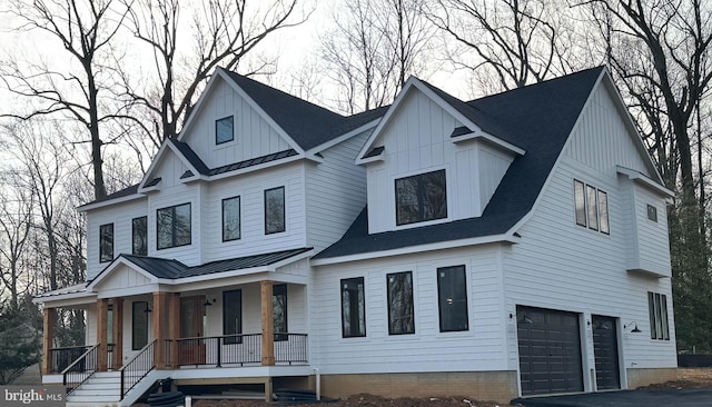 modern farmhouse with a porch and a garage