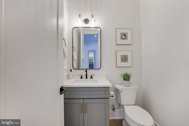 bathroom featuring toilet and vanity