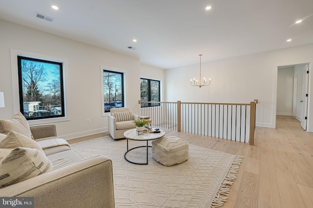 living room featuring light hardwood / wood-style flooring and a chandelier