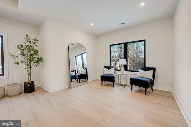 sitting room featuring light wood-type flooring and plenty of natural light