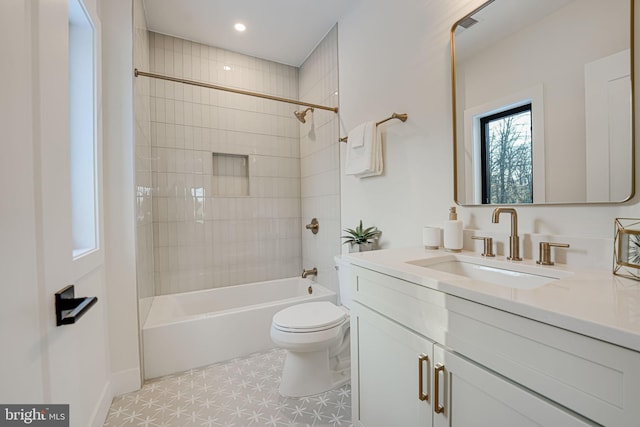 full bathroom with vanity, tile patterned flooring, tiled shower / bath combo, and toilet