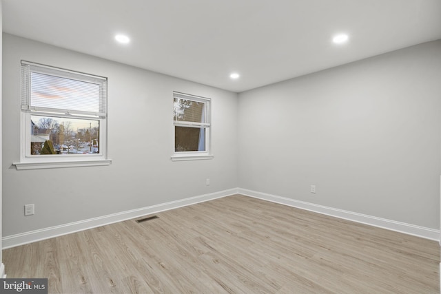 empty room with light hardwood / wood-style floors