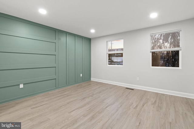 unfurnished room with light hardwood / wood-style floors