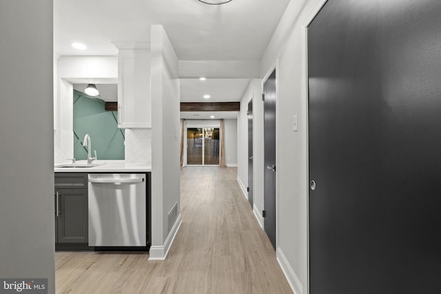 hallway with light wood-type flooring and sink