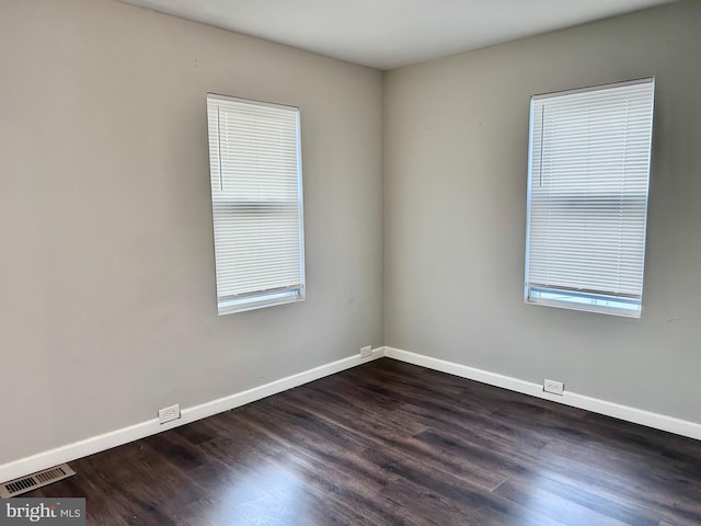 spare room with dark wood-type flooring