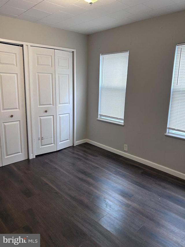 unfurnished bedroom featuring dark wood-type flooring