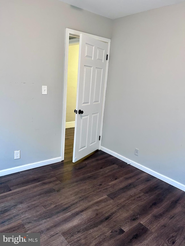 unfurnished room with dark hardwood / wood-style floors