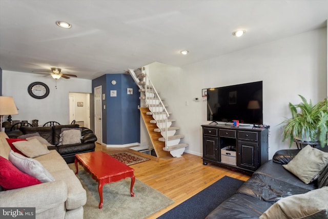 living room featuring ceiling fan and hardwood / wood-style flooring