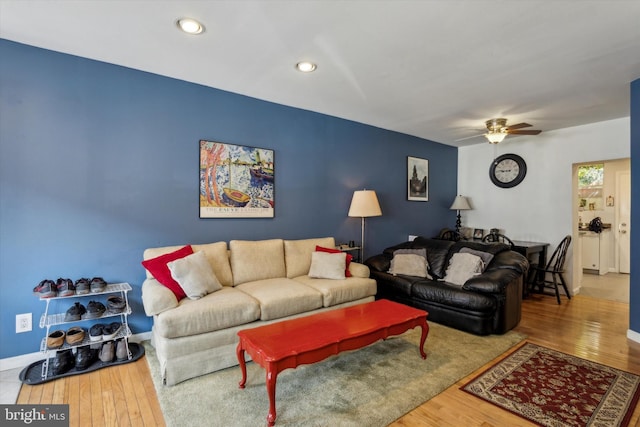 living room featuring hardwood / wood-style flooring and ceiling fan