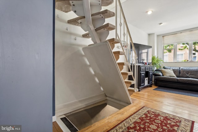 stairway featuring hardwood / wood-style floors