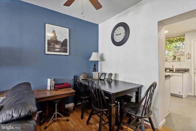 dining area featuring light wood-type flooring and ceiling fan