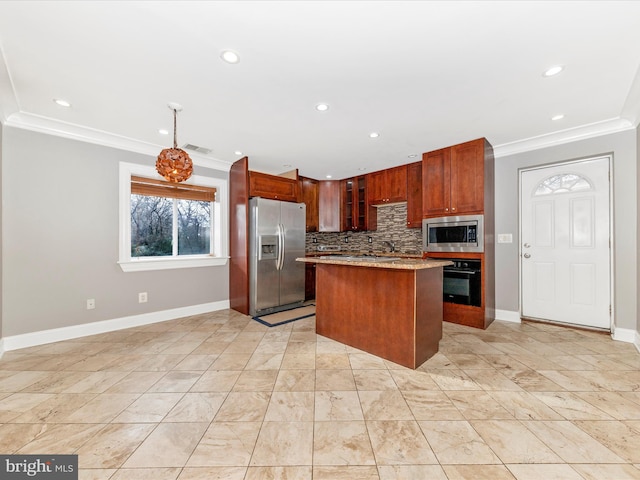 kitchen featuring light stone counters, appliances with stainless steel finishes, decorative backsplash, a kitchen island, and ornamental molding