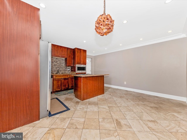 kitchen featuring a center island, stainless steel microwave, backsplash, decorative light fixtures, and white fridge