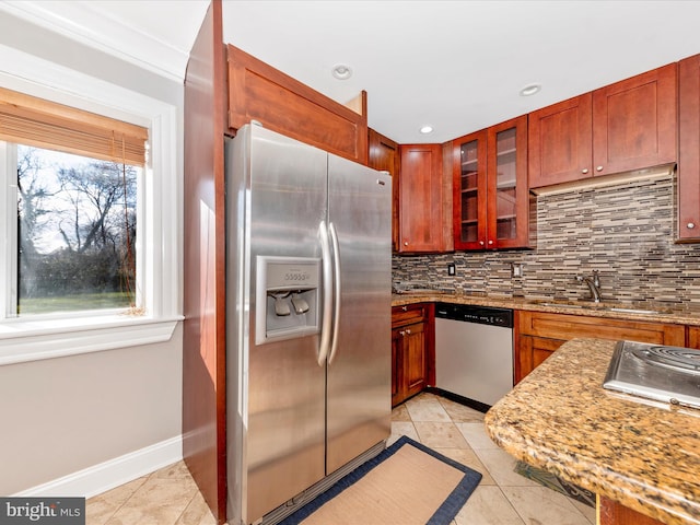 kitchen featuring sink, decorative backsplash, appliances with stainless steel finishes, light tile patterned flooring, and light stone counters