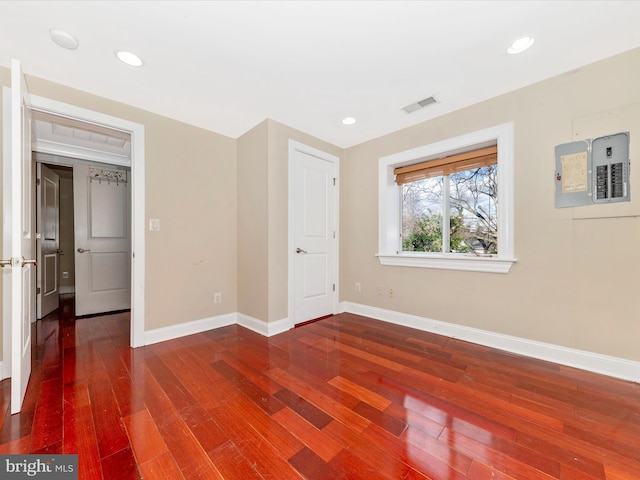 unfurnished bedroom with electric panel and wood-type flooring