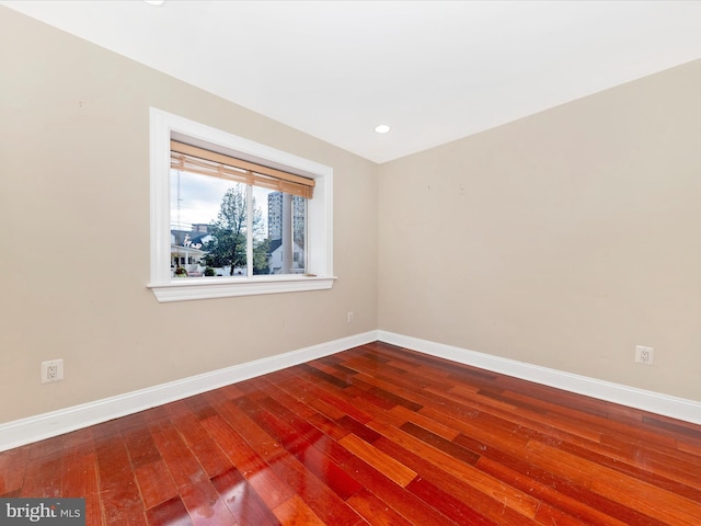 empty room with hardwood / wood-style flooring