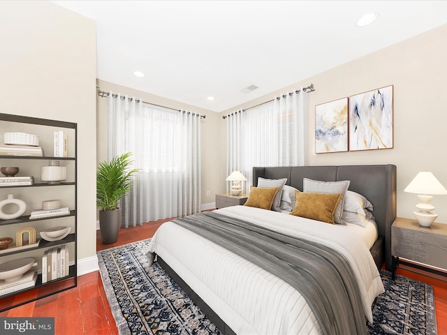 bedroom with dark wood-type flooring