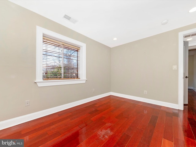 unfurnished room with wood-type flooring