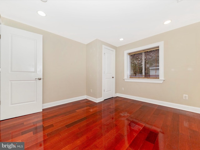 spare room featuring wood-type flooring